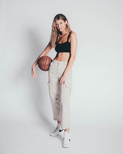 woman in black tank top and white pants